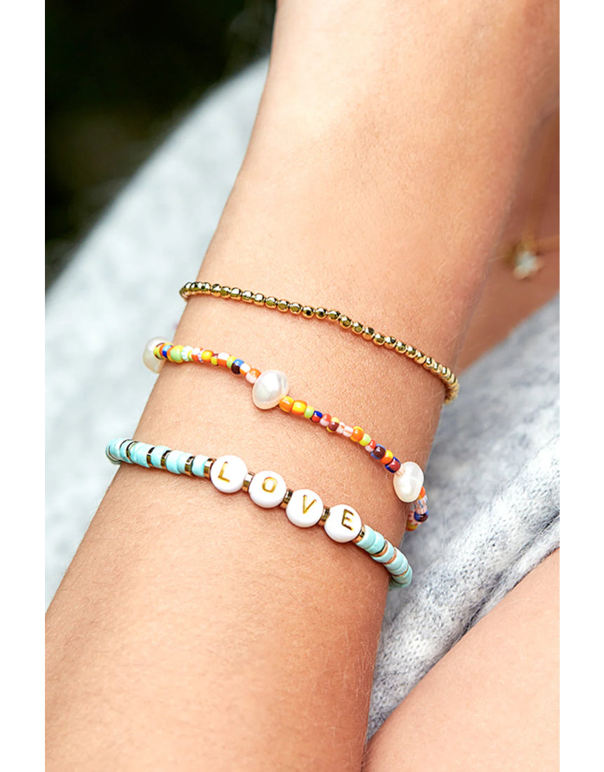 Estella Bartlett rainbow pearl bracelet set featuring colorful pearl designs on delicate bracelets for a stylish accessory.