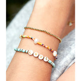 Estella Bartlett rainbow pearl bracelet set featuring colorful pearl designs on delicate bracelets for a stylish accessory.