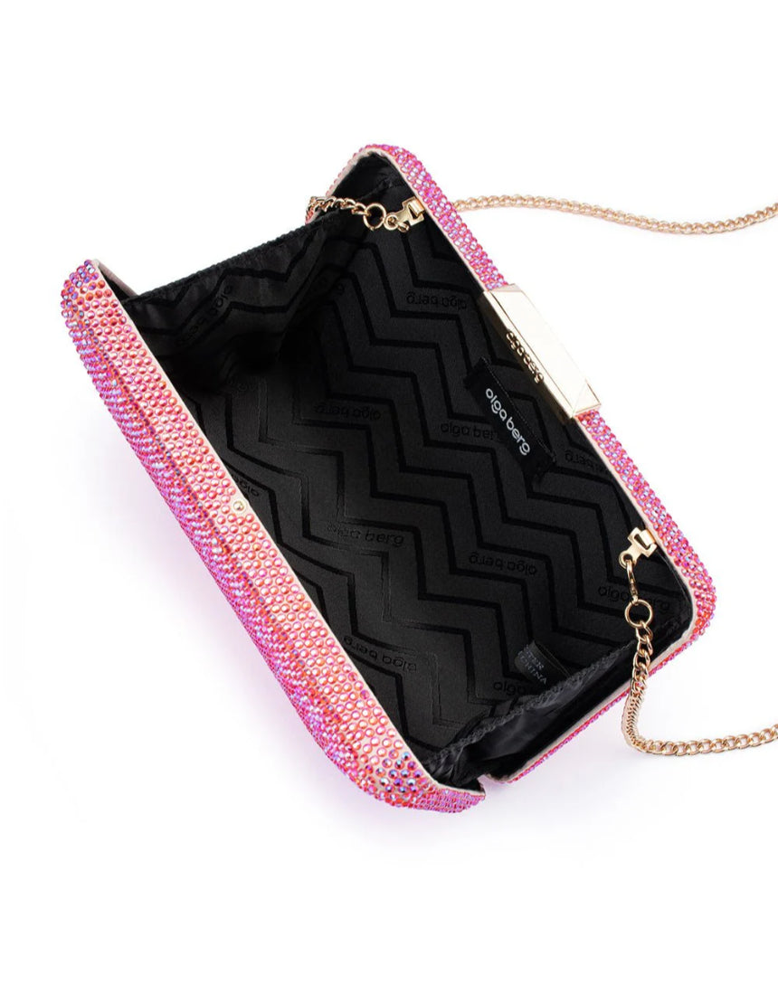 Olga Berg Edith iridescent pink clutch bag with a sleek, shiny finish and metallic accents on a plain background.
