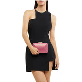Olga Berg Edith iridescent pink clutch bag with a sleek, shiny finish and compact design.