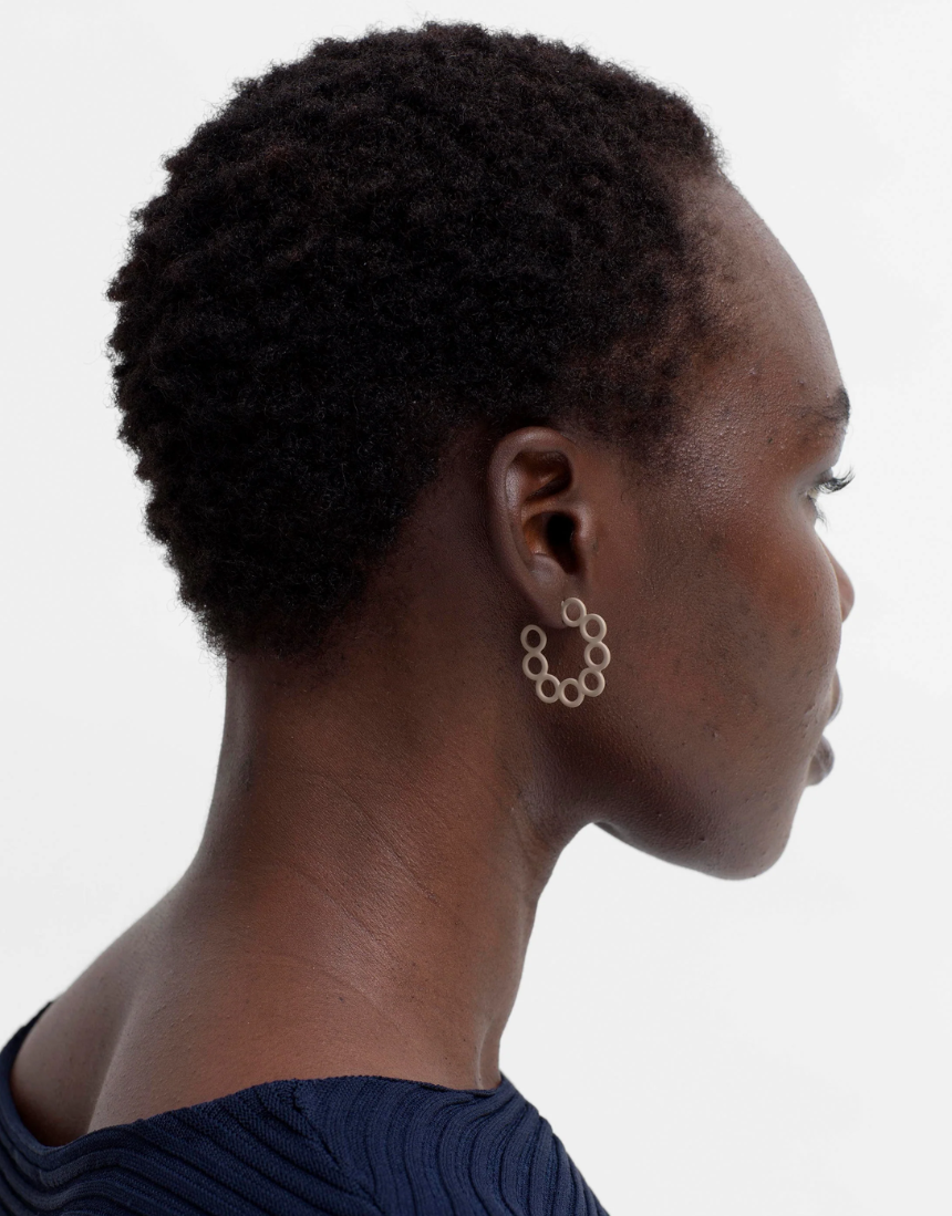 Ecru Tutra earring by Elk, showcasing a delicate accessory with intricate design and elegant craftsmanship.