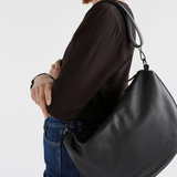 Black Elk Ilin Crossbody Bag showing adjustable strap, sleek design, and compact size for everyday carry.