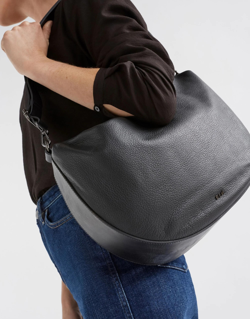 Black Elk Ilin Crossbody Bag with adjustable strap and sleek design, featuring compact storage and modern style.