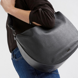 Black Elk Ilin Crossbody Bag with adjustable strap and sleek design, featuring compact storage and modern style.