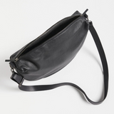Black Elk Ilin Crossbody Bag shown with adjustable strap and sleek design, perfect for everyday use.