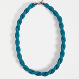 Elk Kolle Necklace in teal with a sleek, minimalist design, featuring a smooth, curved pendant on a delicate chain.