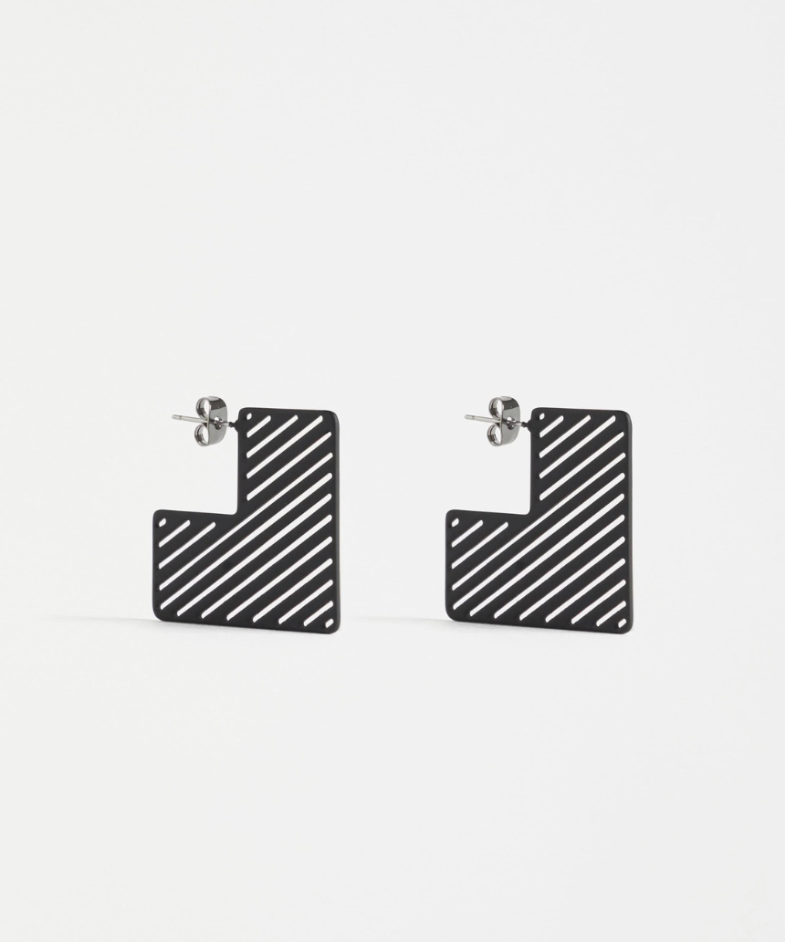 Black Elk Skaret Hoop Earring featuring a sleek, minimalist design with a smooth finish and circular shape.