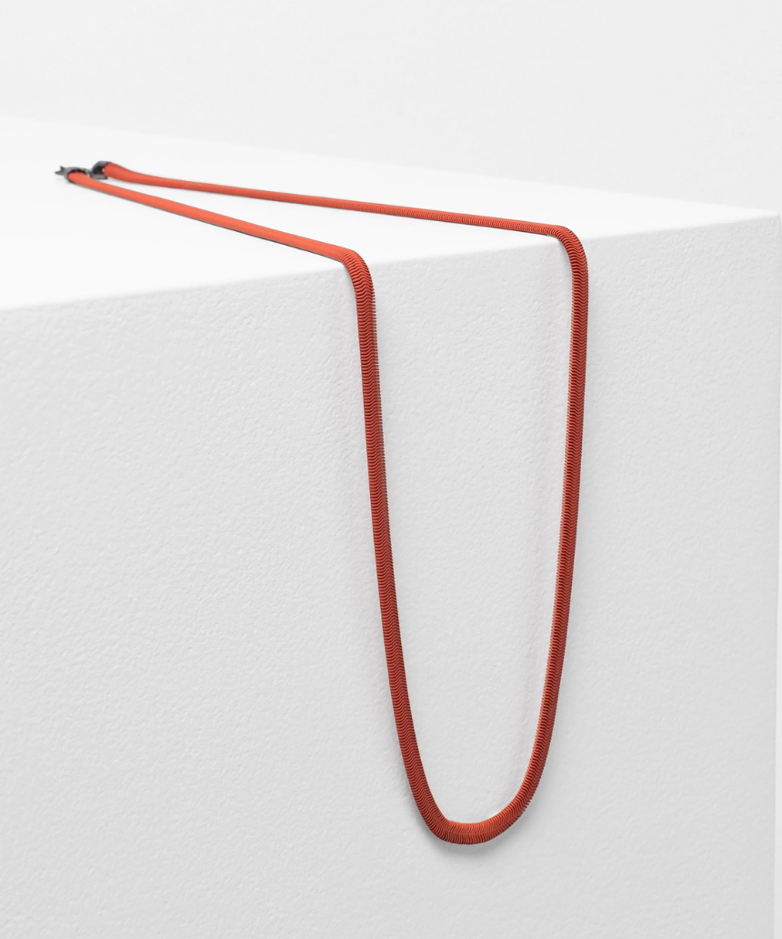 Elk Vell Long Necklace in vibrant flame orange with delicate chain and pendant, stylish jewelry accessory.