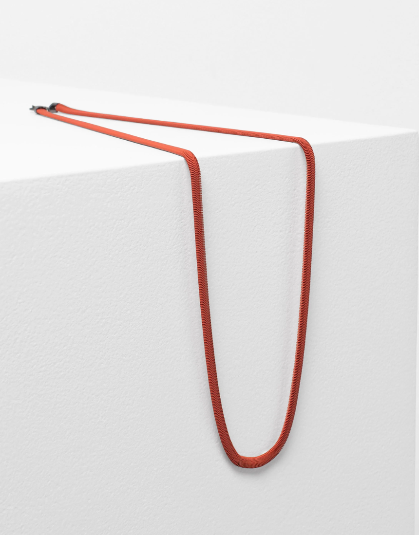 Elk Vell Long Necklace in vibrant flame orange with delicate chain and pendant, stylish jewelry accessory.