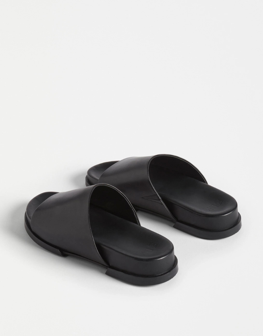 Black Elk Etin Slide shoes featuring a sleek design and comfortable straps, perfect for casual wear.