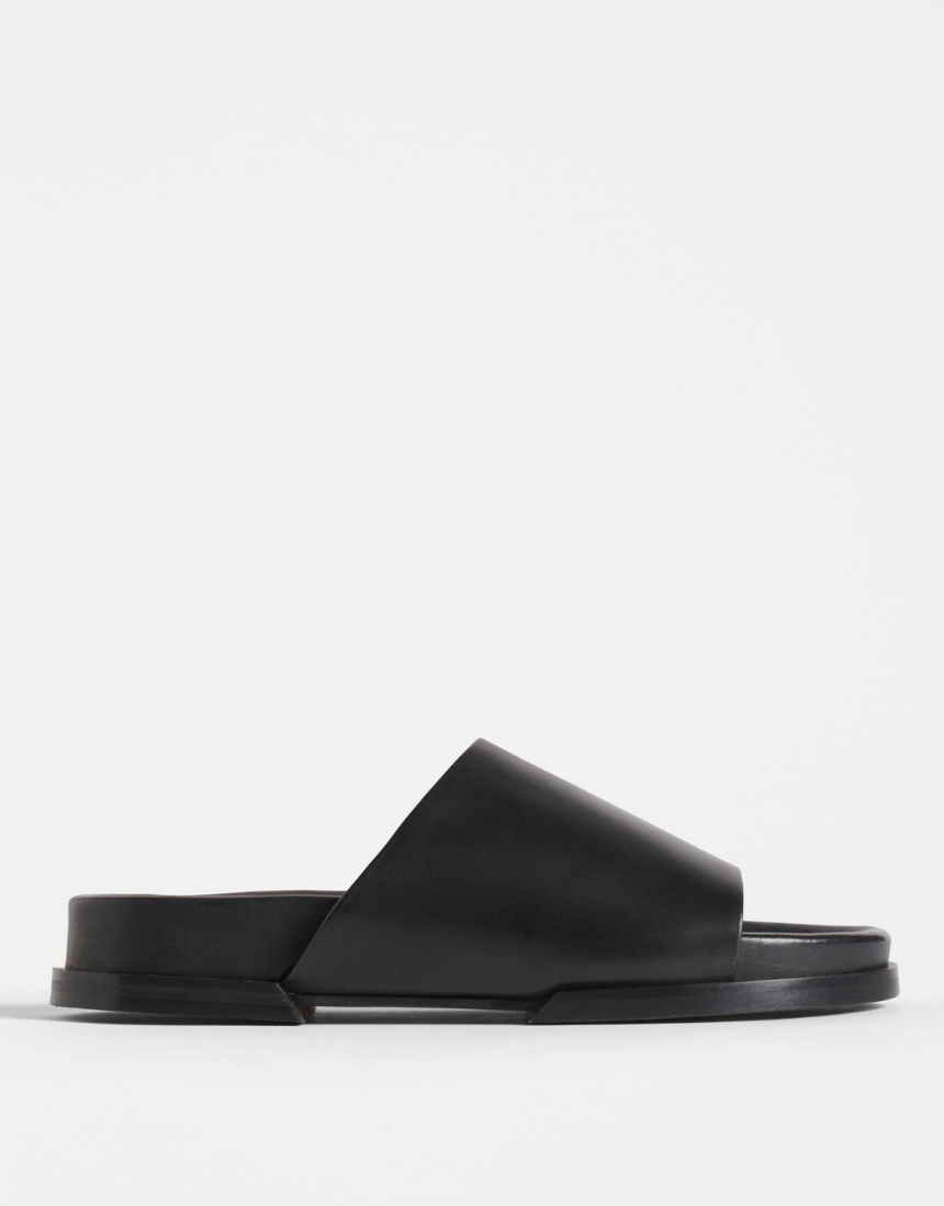 Black Elk Etin Slide shoes featuring a sleek design and comfortable slip-on style for casual wear.