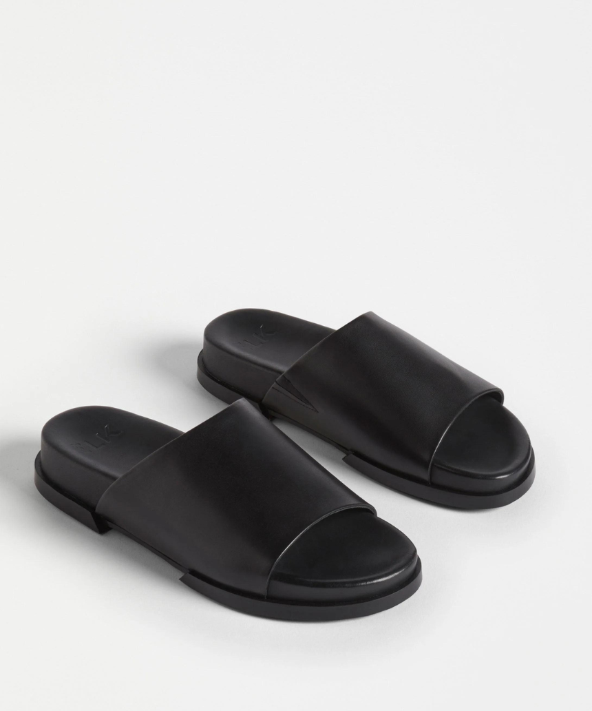 Black Elk Etin Slide shoes featuring a sleek design, perfect for casual wear and easy to slip on.