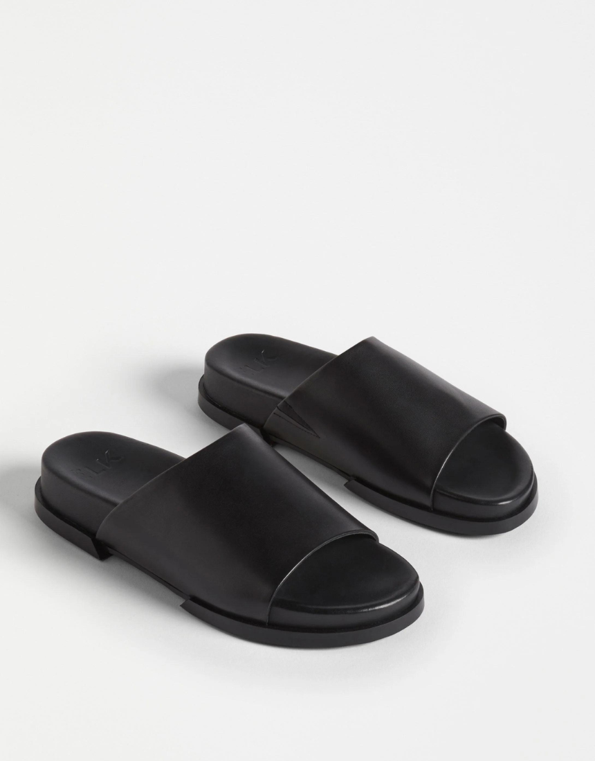 Black Elk Etin Slide shoes featuring a sleek design, perfect for casual wear and easy to slip on.