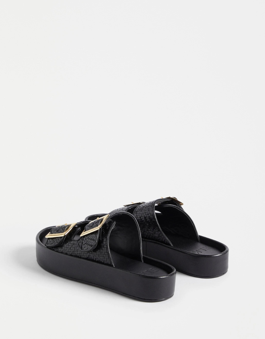 Black Elk Turi Platform shoes featuring a sleek design with sturdy soles and stylish ankle straps.