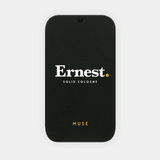 Ernest Muse Solid Cologne in a compact container, featuring a sleek design and the brand’s minimalist style.