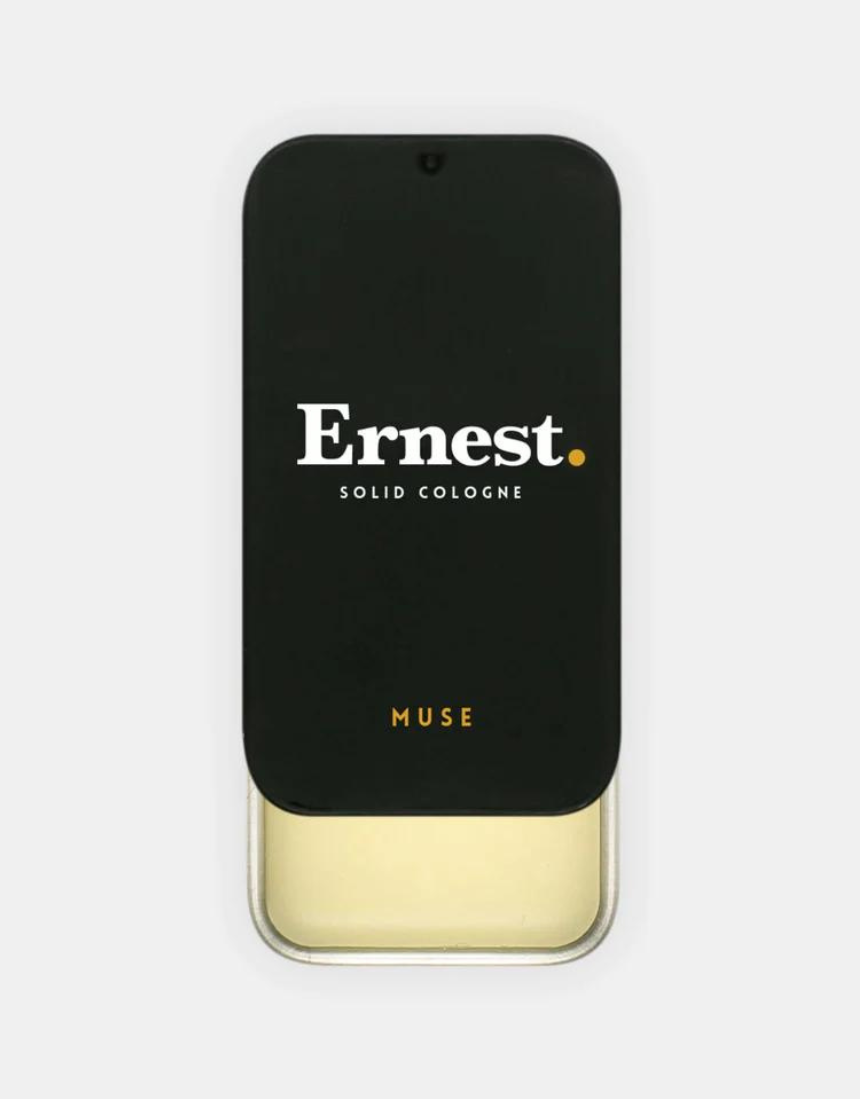 Ernest Muse solid cologne in a sleek container, featuring a smooth, rounded design ideal for portable fragrance.