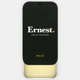 Ernest Muse solid cologne in a sleek container, featuring a smooth, rounded design ideal for portable fragrance.