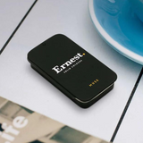 Ernest Muse solid cologne in a sleek container, featuring a minimalist design and a smooth, solid fragrance surface.
