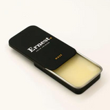 Ernest Muse Solid Cologne in a sleek, black jar with a smooth, rounded lid, showcasing the stylish packaging and product texture.
