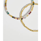 Estella Bartlett Coco & Tourmaline bracelet featuring a delicate chain and colorful tourmaline stones on a jewelry display.