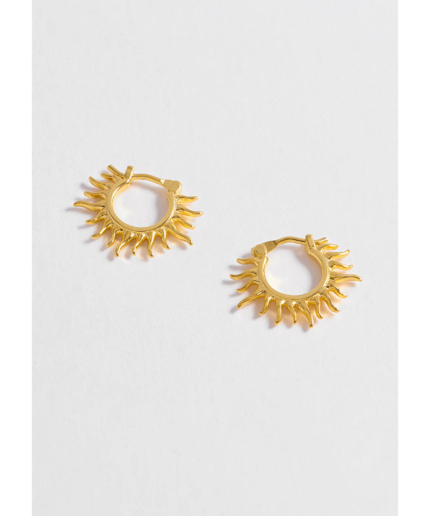 Estella Bartlett Sun Huggie Hoop Earring featuring a small sun charm on gold-tone hoop earring, perfect for everyday wear.