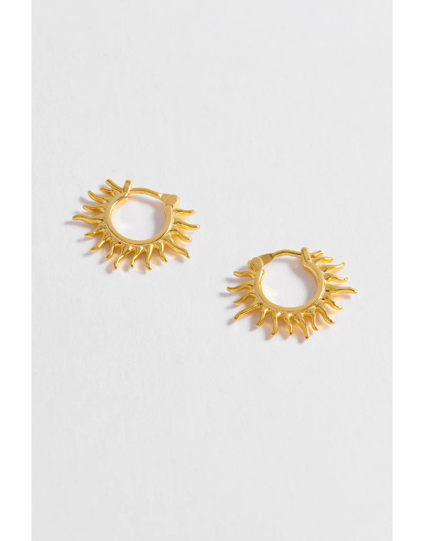 Estella Bartlett Sun Huggie Hoop Earring featuring a small sun charm on gold-tone hoop earring, perfect for everyday wear.