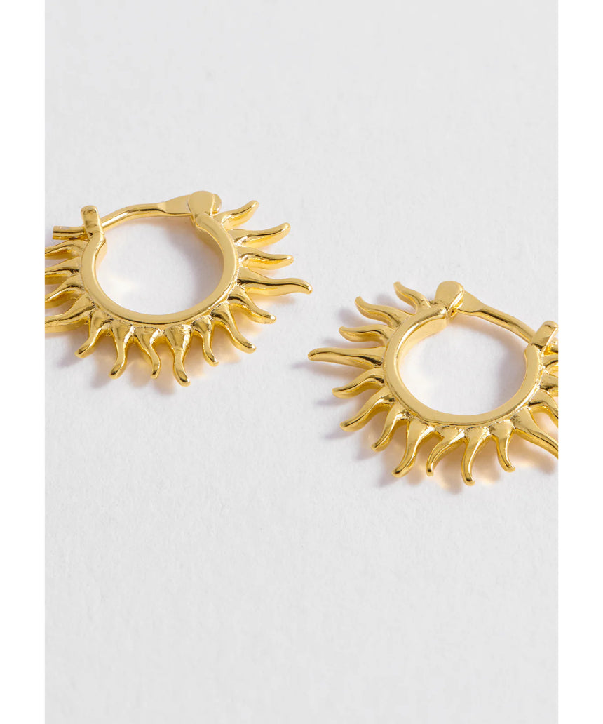 Estella Bartlett Sun Huggie Hoop Earring featuring a gold-tone sun design and small hoop style, perfect for everyday wear.