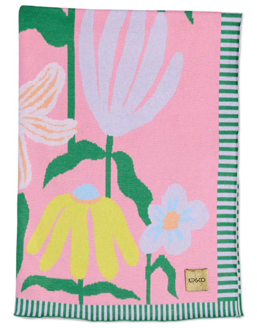 Kip & Co Popping Flowers Green cotton knitted blanket with colorful floral pattern, cozy and soft for bedding or lounging.