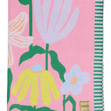 Kip & Co Popping Flowers Green cotton knitted blanket with colorful floral pattern, cozy and soft for bedding or lounging.