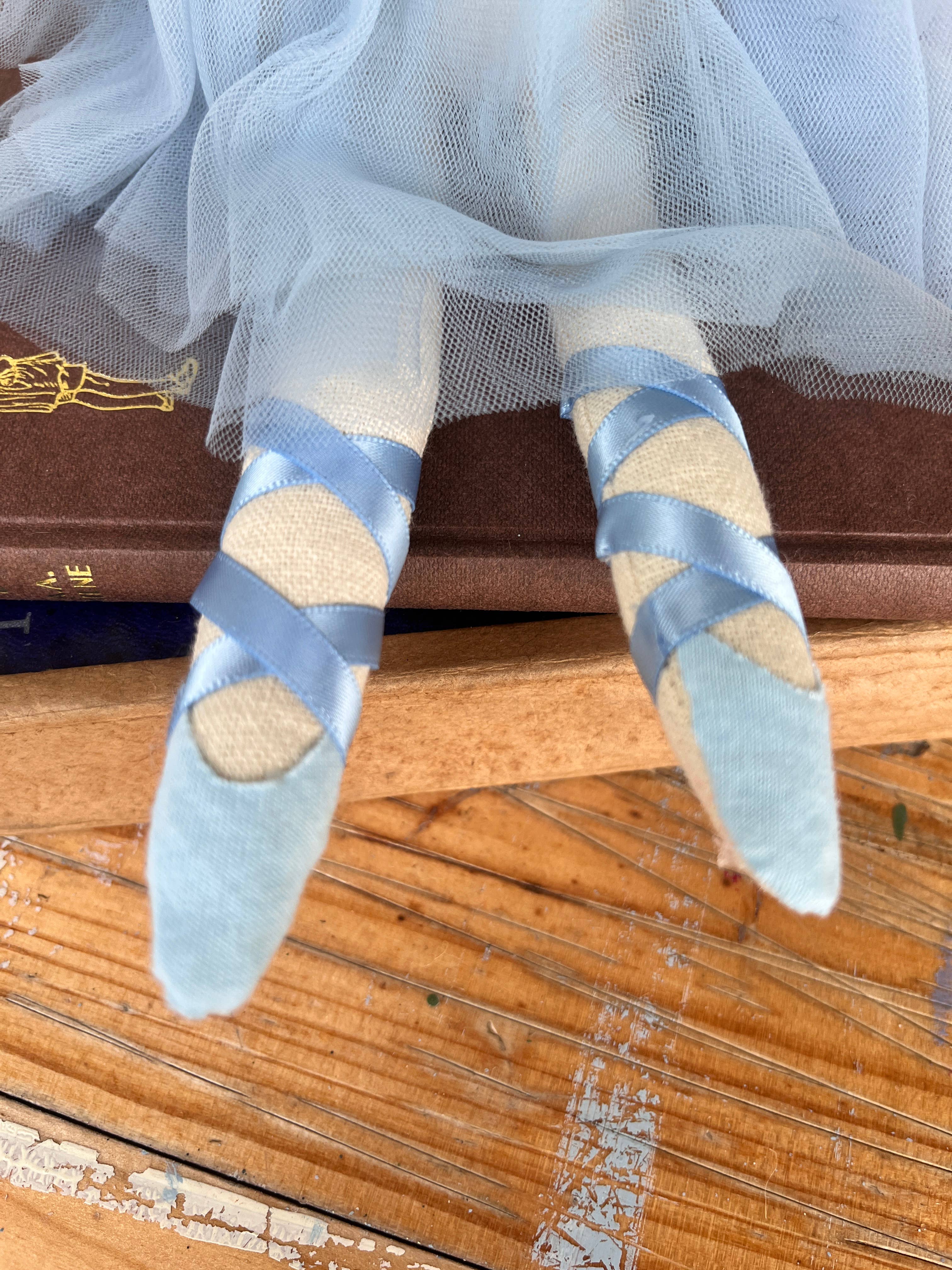 Amaranta Designs ballerina doll with pink tutu and ballet shoes, featuring detailed face and hair, standing in a graceful pose.