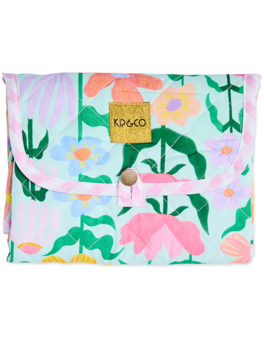 Kip & Co Popping Flowers Green baby change mat with vibrant floral pattern and soft padded surface for comfortable diaper changes.
