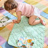 Kip & Co Cheer Up baby change mat with colorful, cheerful pattern on soft cushioned surface for comfortable changing.
