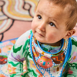 Kip & Co Happy Stars dribble bib set featuring cheerful star patterns, soft fabric, and adjustable neck closures for babies.