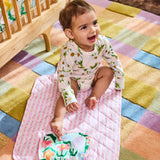 Kip & Co green baby change mat with colorful floral pattern, soft padded surface for comfortable diaper changes.