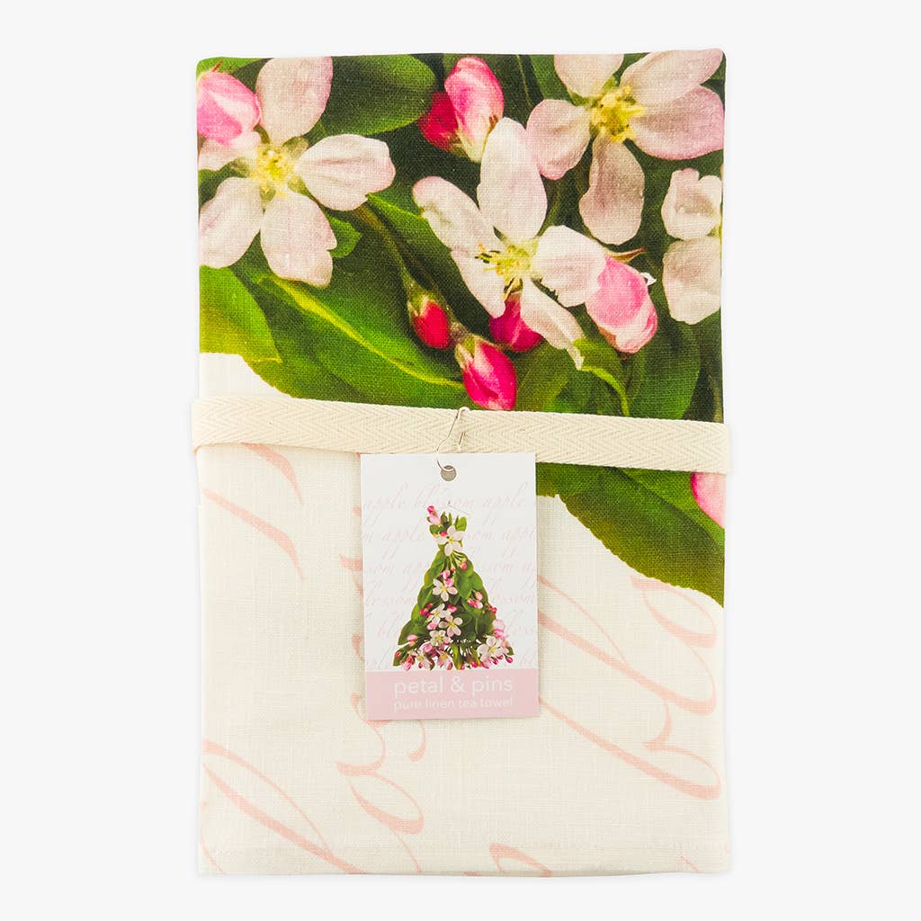 Petal & Pins floral pure linen tea towel with apple blossom design, showcasing a bright, colorful floral pattern on textured linen fabric.