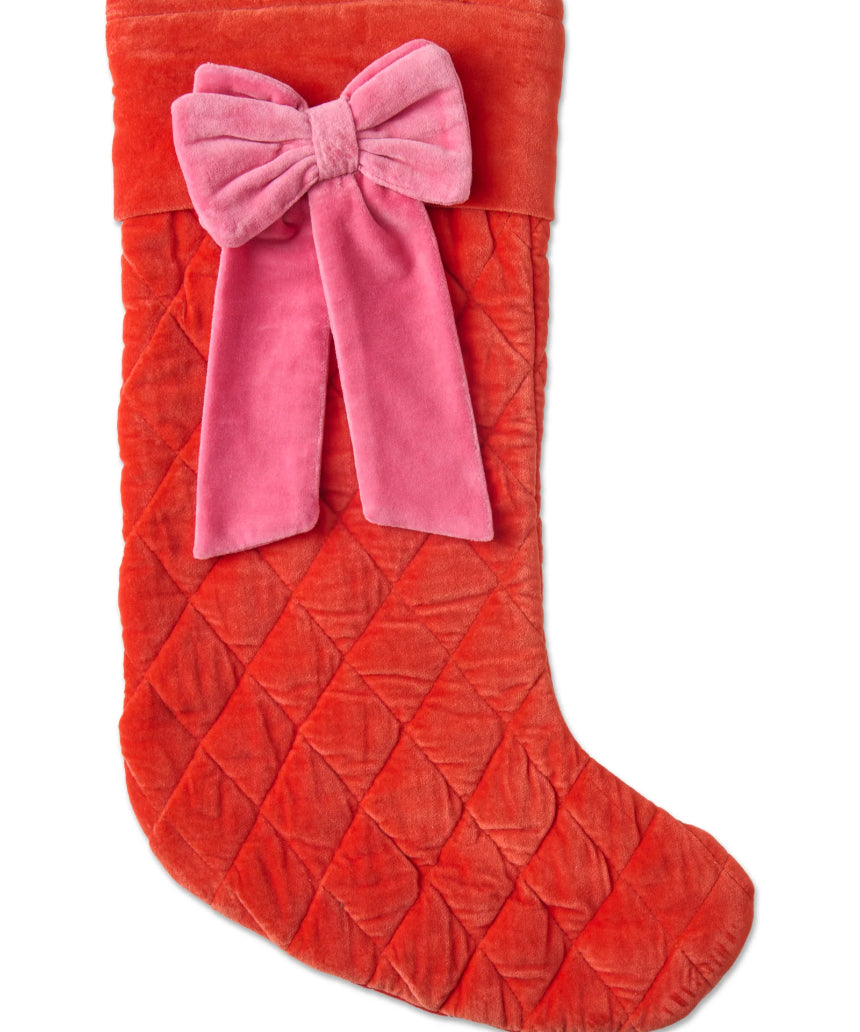 Kip & Co Christmas Bow Velvet Stocking hanging with red and green holiday decorations, festive Christmas decoration.