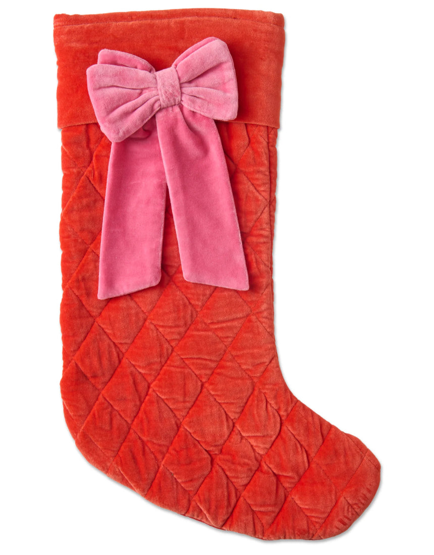 Kip & Co Christmas Bow Velvet Stocking hanging with red and green holiday decorations, festive Christmas decoration.