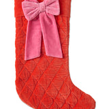 Kip & Co Christmas Bow Velvet Stocking hanging with red and green holiday decorations, festive Christmas decoration.