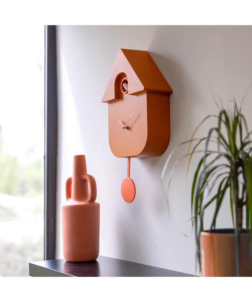 Terracotta Fisura cuckoo clock with wooden details and a traditional design, showcasing the clock face and cuckoo bird opening.