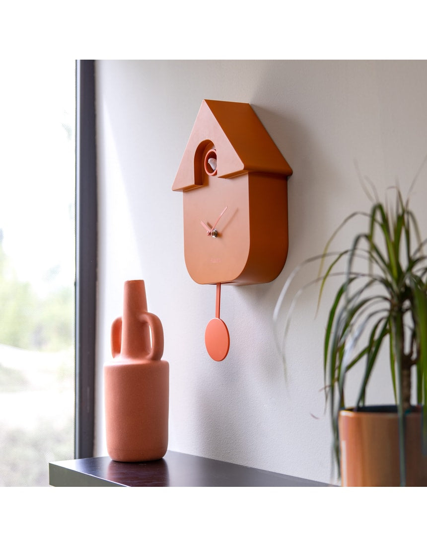 Terracotta Fisura cuckoo clock with wooden details and a traditional design, showcasing the clock face and cuckoo bird opening.
