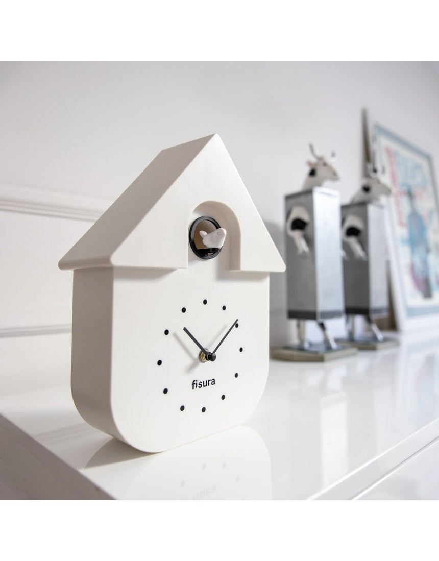 White Fisura cuckoo clock with traditional design, featuring a wooden case and a small cuckoo door on the front.