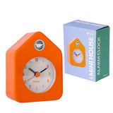 Fisura Little House alarm clock in orange with a charming house shape and clock face, perfect for bedside or decorative use.