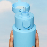 Frank Green drinkwear switch lid with straw and strap in blush color, featuring a secure fit and convenient carry strap.
