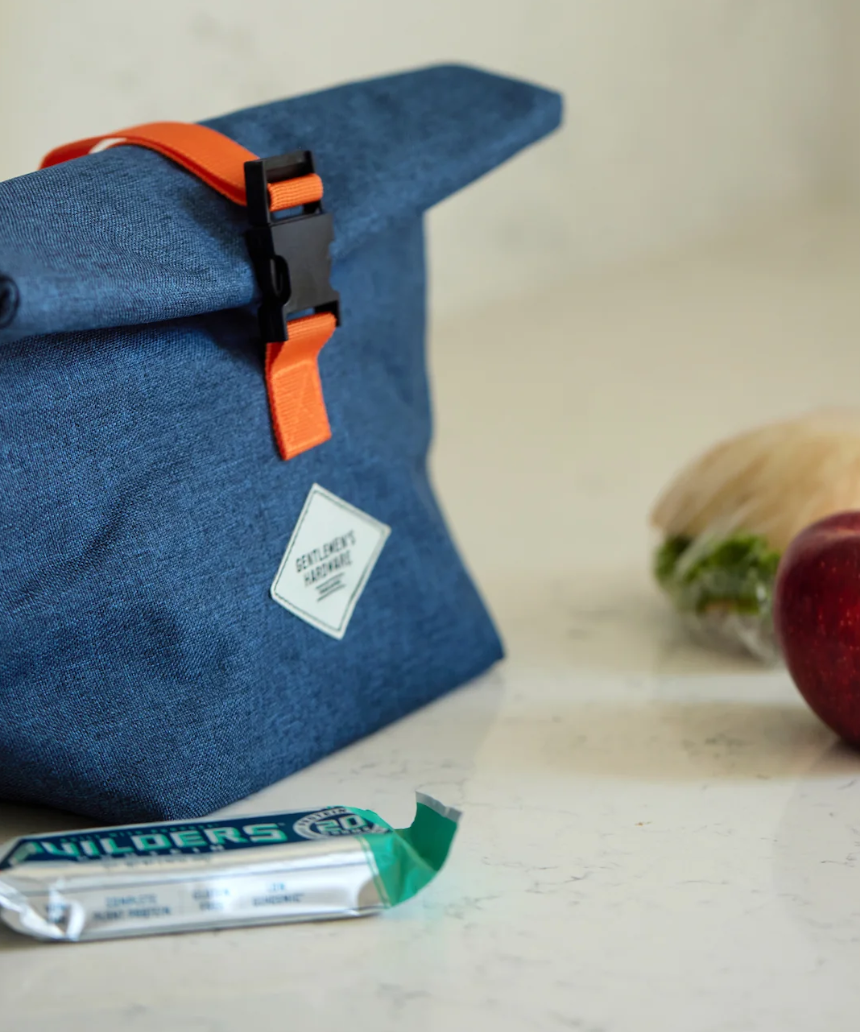 Gentlemen's Hardware roll-top lunch bag featuring durable fabric and a secure closure, ideal for carrying meals on the go.