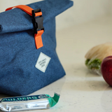 Gentlemen's Hardware roll-top lunch bag featuring durable fabric and a secure closure, ideal for carrying meals on the go.