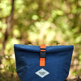 Gentlemen's Hardware roll-top lunch bag with durable fabric and adjustable strap, suitable for carrying lunch on the go.