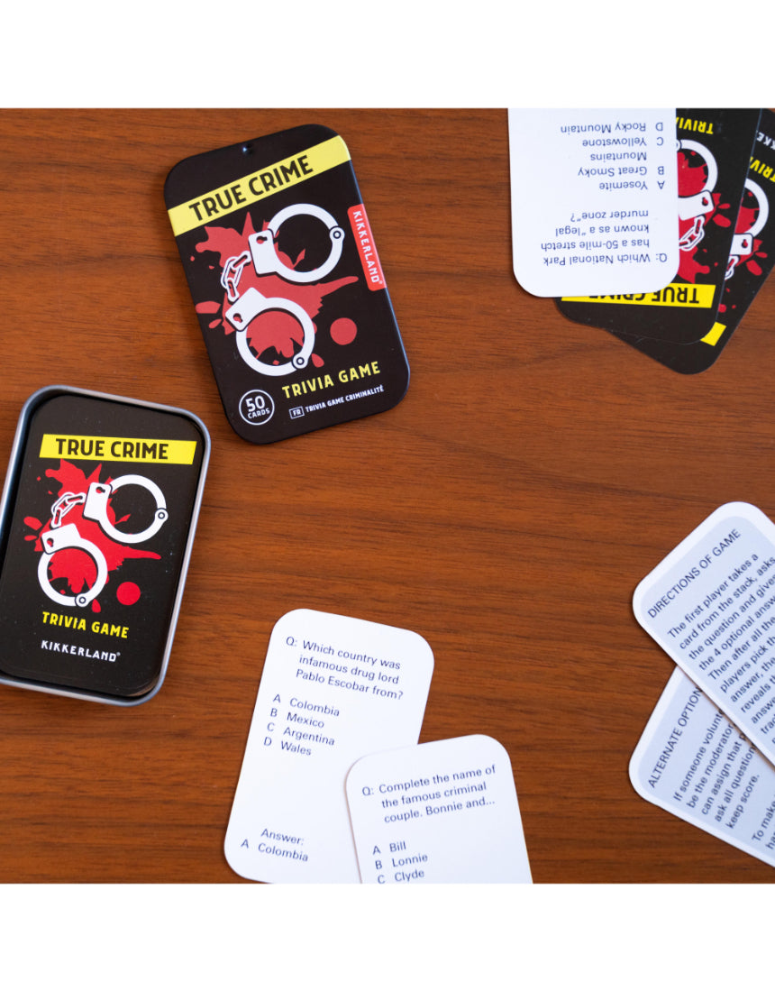 True Crime Trivia Tin by isAlbi showing a metal tin with trivia cards and related game accessories inside.