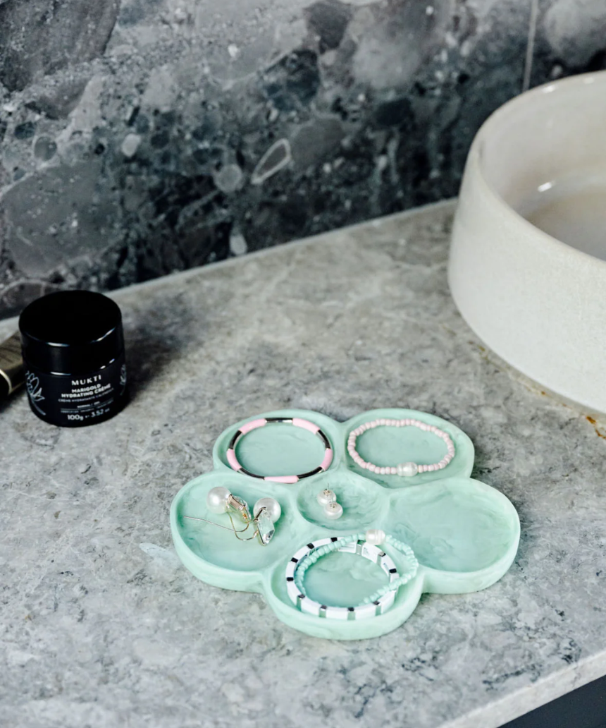 Greenwood Designs flower-shaped jewelry tray in mint color, perfect for organizing rings and necklaces.