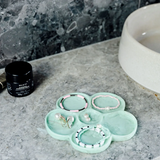 Greenwood Designs flower-shaped jewelry tray in mint color, perfect for organizing rings and necklaces.