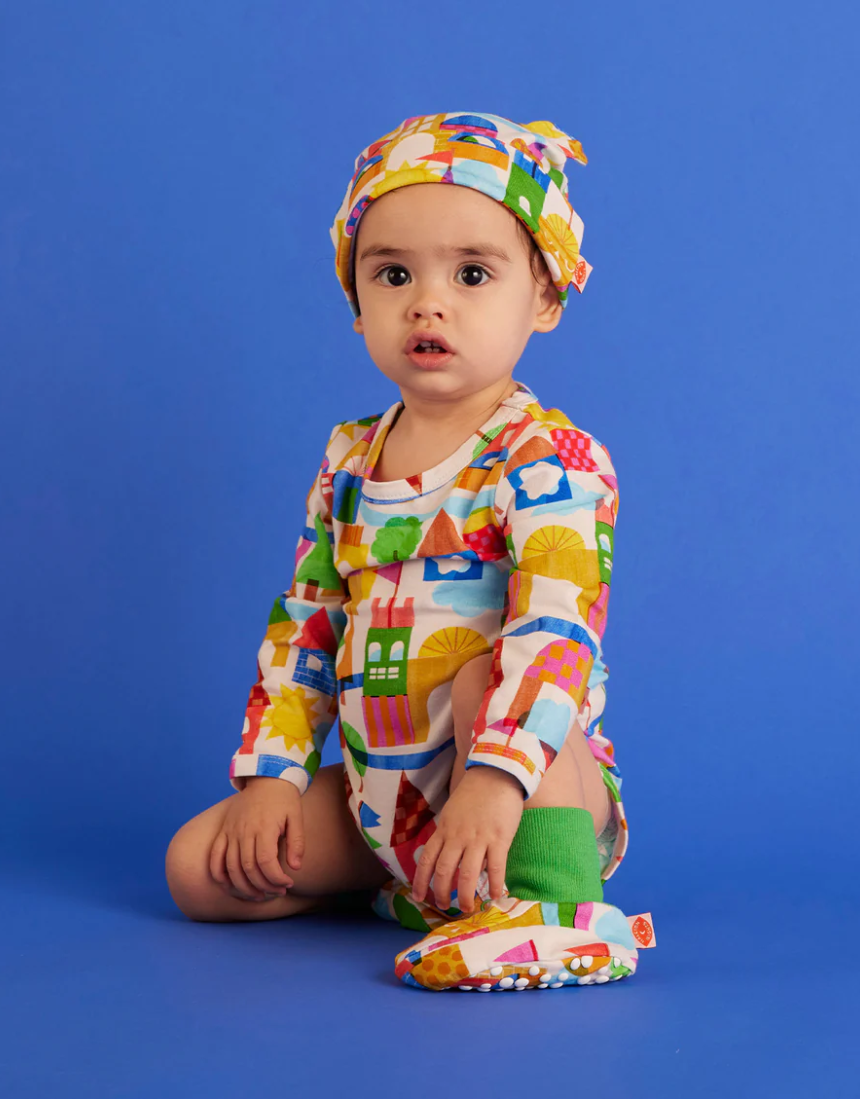 Baby long sleeve bodysuit by Halcyon Nights featuring a whimsical castle of dreams design for newborns aged 0-3 months.
